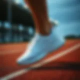 Stylish white running shoes on a track